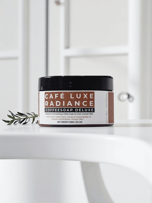 Café Luxe Radiance Coffeesoap Deluxe in a sleek container on a white surface, highlighting its nourishing formula.