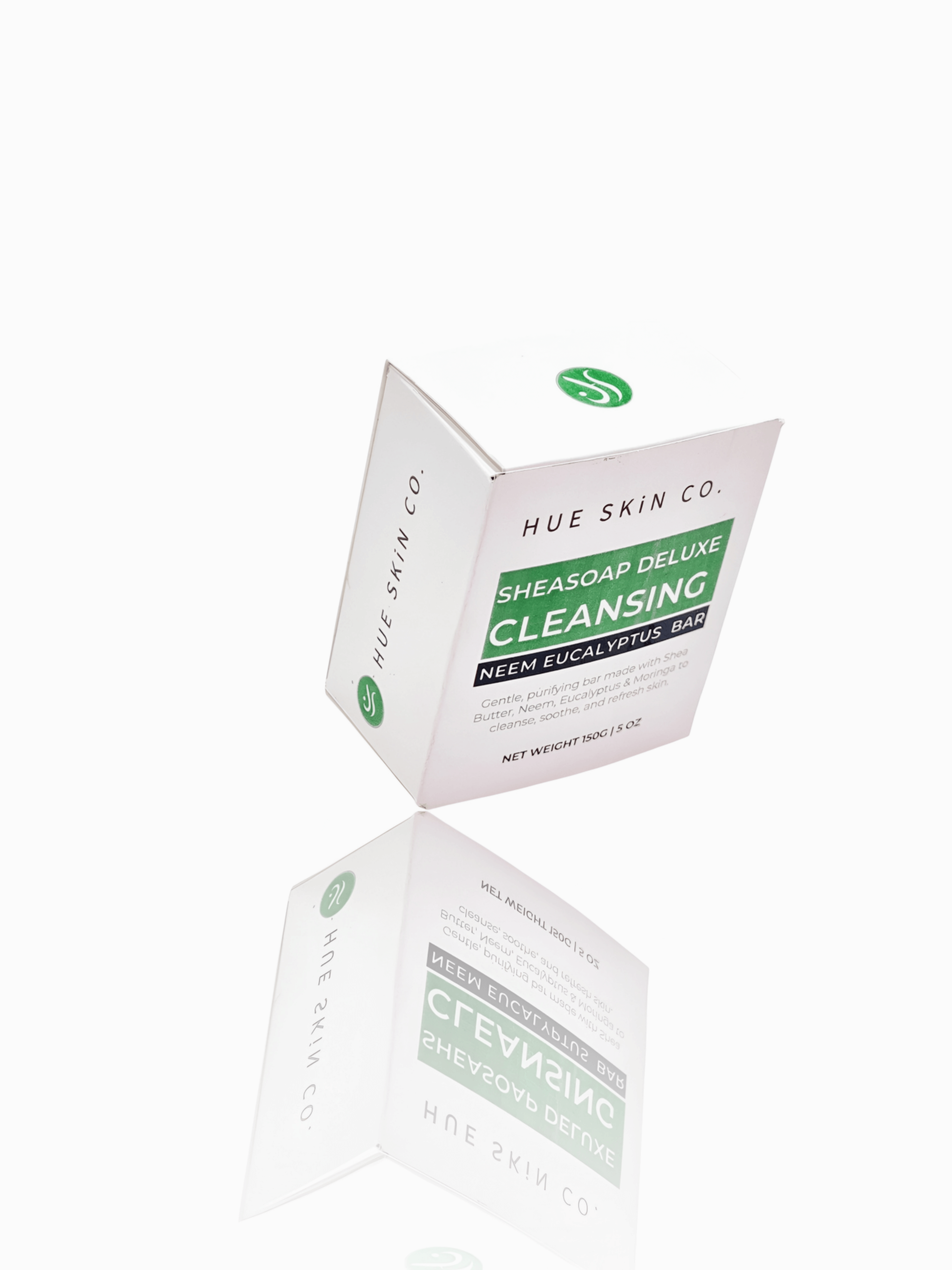 Sheasoap Deluxe Cleansing Neem Eucalyptus Bar packaging on a reflective surface.