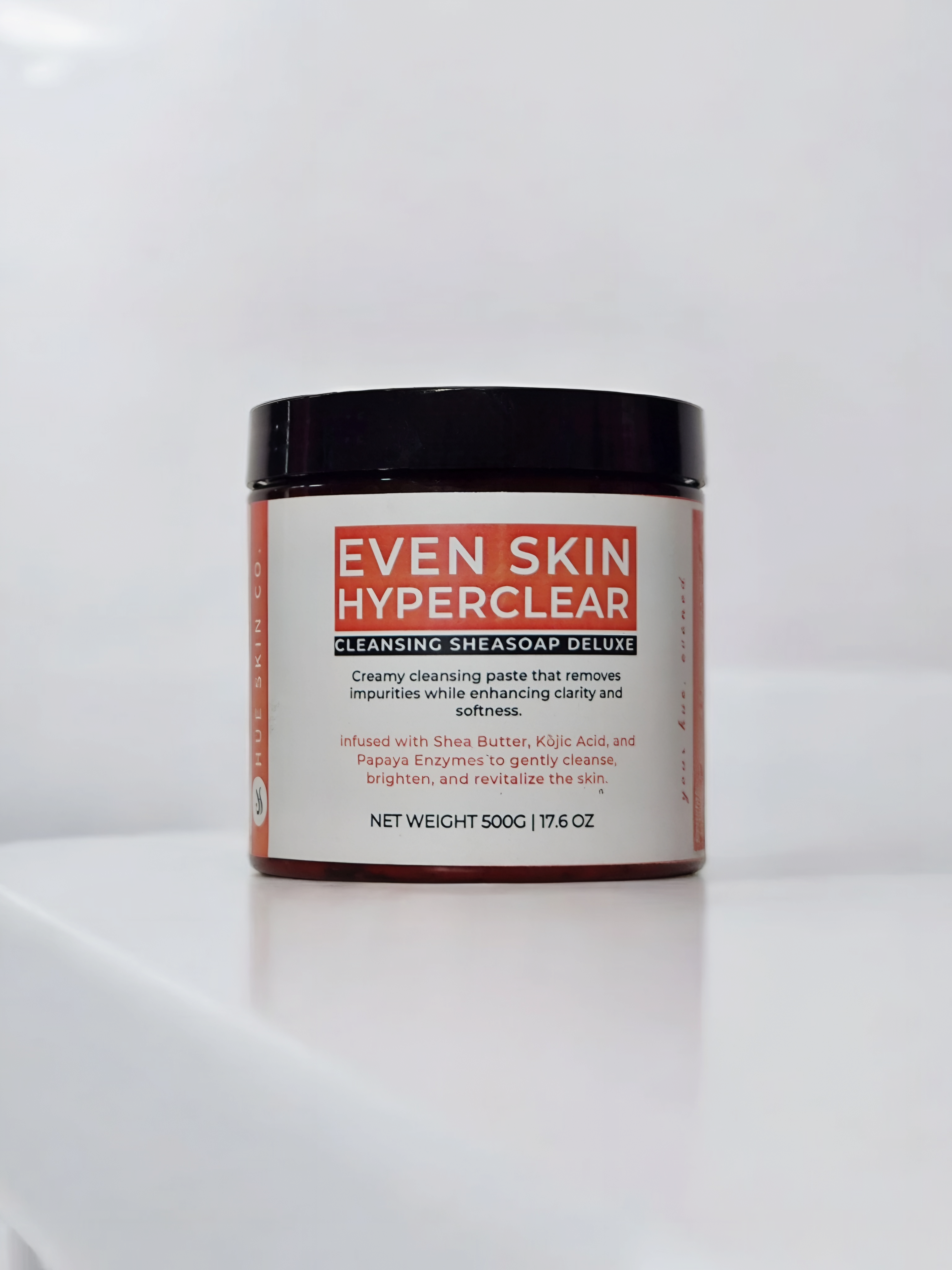 Jar of Even Skin Hyperclear cleansing shea soap on a white background