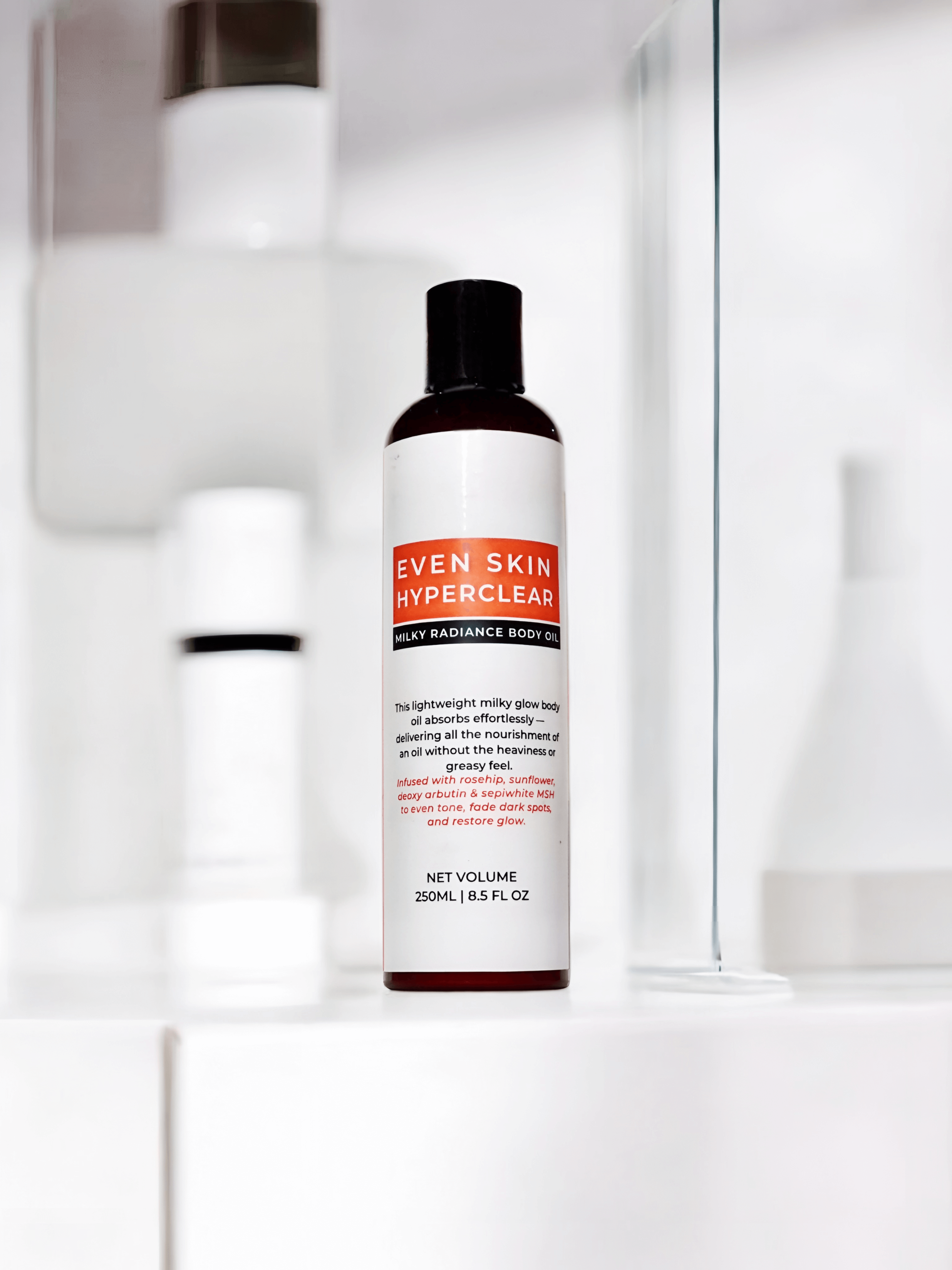 Even Skin HyperClear Milky Radiance Body Oil displayed on a bathroom shelf, showcasing its nourishing properties.