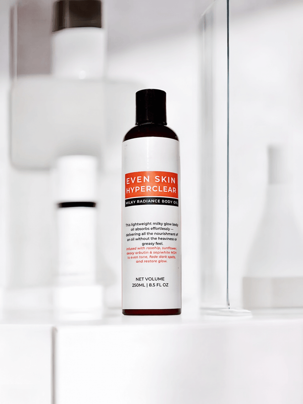 Even Skin HyperClear Milky Radiance Body Oil displayed on a bathroom shelf, showcasing its nourishing properties.